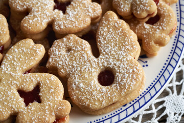 Chicken and bunny shaped Linzer Easter cookies filled with marmalade and dusted with sugar