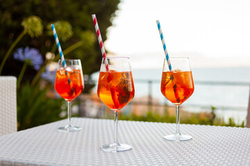 Three aperol spritz on a summer evening in a mediterranean pub - 737528027