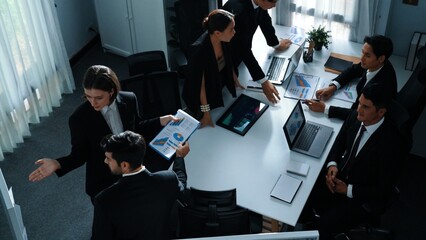 Top view businesspeople placed tablet at table and planning strategy while diverse team discuss...