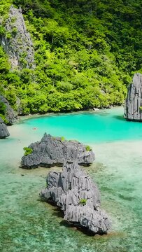 Ubugon Cove with white beach and Cadlao Lagoon with turquoise sea water and corals. Cadlao Island. El Nido. Palawan, Philippines. Vertical view.