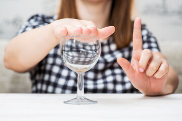 Woman Refusing Glass of Water Signifying No Drinking - obrazy, fototapety, plakaty