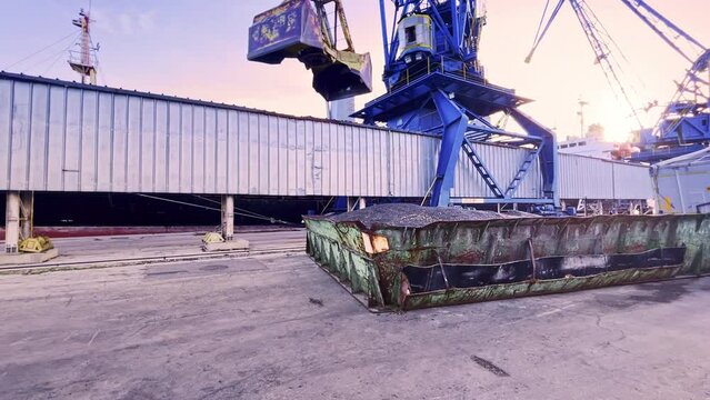 harbor crane loads high oleic sunflower seeds onto cargo ship. Delivery of grain