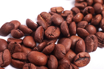 Macro of coffee beans on a white background. Background wallpaper. Roasted Arabica beans
