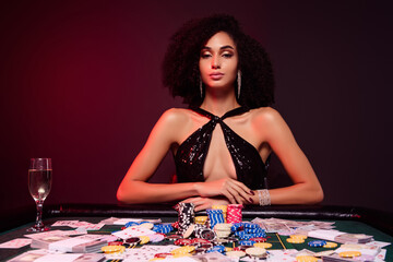 Photo of chic all in poker dealer lady with incredible jackpot wait for players doing stakes bet in...