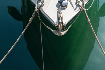 a close up of a part of a sailboat front with ropes