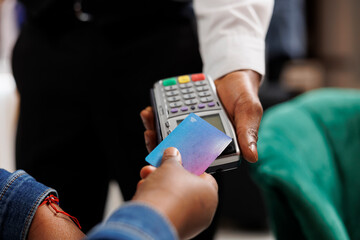 Cashless payments in hotels. Hospitality worker holding pos terminal accepting credit card payment...