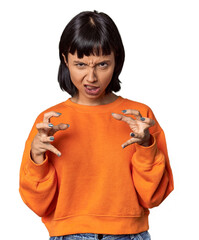 Young Hispanic woman with short black hair in studio upset screaming with tense hands.