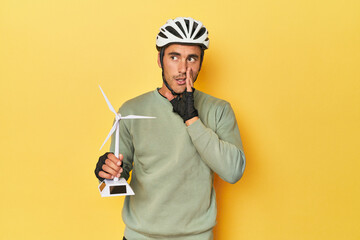 Cyclist with windmill, clean transport theme is saying a secret hot braking news and looking aside