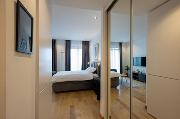 Modern apartment interior with large mirrors