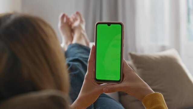 Girl watching mockup phone laying sofa closeup. Woman reading electronic book