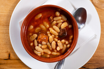 Popular delicious dish of Spanish cuisine is Fabada soup, made from white beans with smoked pork...