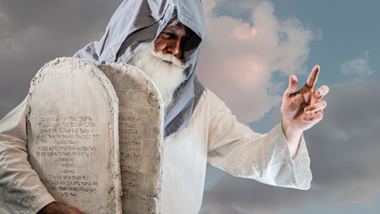 The Old Testament biblical prophet Moses holds the tablets with the ten  commandments