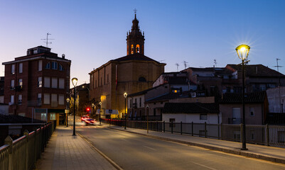 Fototapeta na wymiar Deserted streets of ancient city Cenicero in province of Rioja, northeastern Spain. Soft evening light of lanterns illuminates narrow stone bridges of town Cenicero