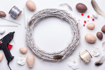 Fototapeta na wymiar Composition with supplies for creating Easter wreath on white table