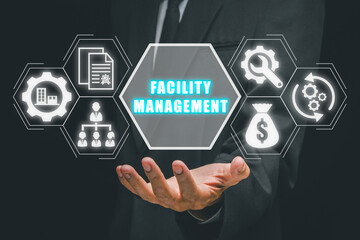 Facility management concept, Businessman hand holding facility management icon on virtual screen.