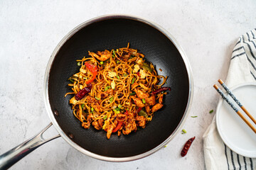 Homemade chicken lomein in a wok , selective focus