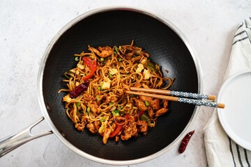 Homemade chicken lomein in a wok , selective focus