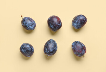 Fresh plums on yellow background