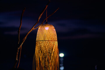 Vietnamese folk lamp on the background of sunset sky and sea on Phu Quoc Island.
