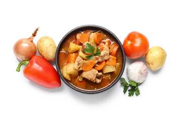 Bowl with delicious beef stew and different ingredients on white background