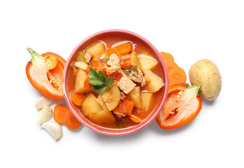 Bowl with delicious beef stew and different ingredients on white background