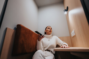 Stunning, female, business professional pauses for a break, engaging in a video call meeting from...