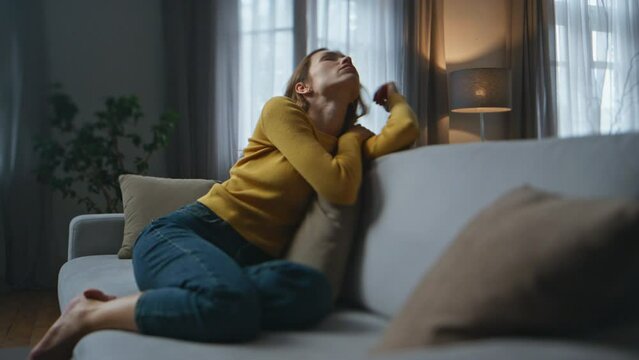 Pensive lady napping sofa resting alone at evening home. Sad woman solitude