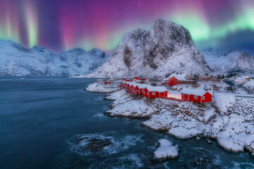 norway lofoten beach and red houses with night northern lights aurora borealis