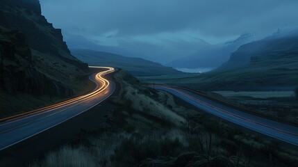 As dusk fell, lights and vehicle traces from cars and trucks could be seen circling along a mountain road between circular ravines - obrazy, fototapety, plakaty