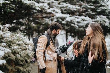 Obraz na płótnie Canvas A dynamic image portraying young colleagues walking outdoors, engaging with each other on a snowy day, with snowflakes and pine trees around.