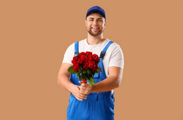 Delivery man with flowers on beige background