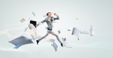 Portrait of energetic businessman jumping in open air - 737653022