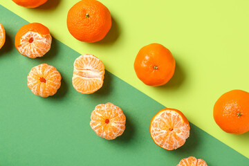Composition with fresh tangerines on green background