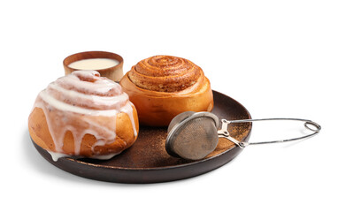 Plate with cinnamon buns, cream and strainer on white background