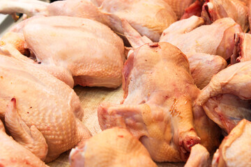 raw chicken on a trader's table at the market