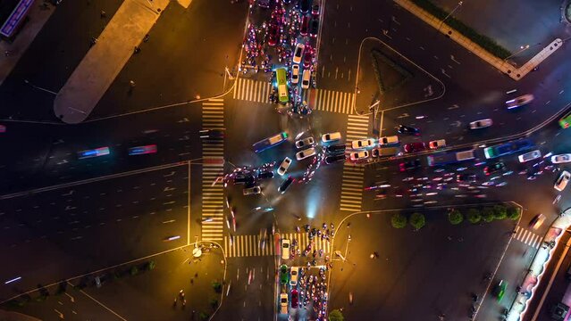 Aerial time-lapse of evening traffic at intersection in Ho Chi Minh City, Vietnam.