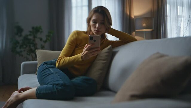 Lonely lady melancholic mood at night flat. Depressed woman thinking problems