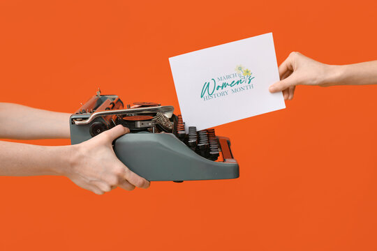 Female hands with retro typewriter and greeting card for International Women's Day on color background, closeup