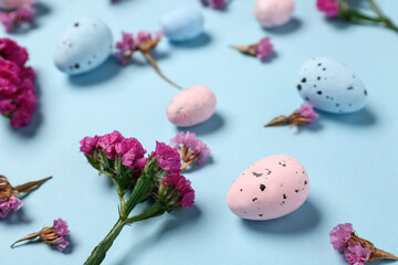 Easter eggs with flowers on blue background