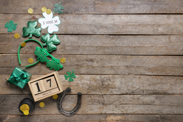 Festive postcard with words HAPPY ST. PATRICK'S DAY, calendar and decor on wooden background