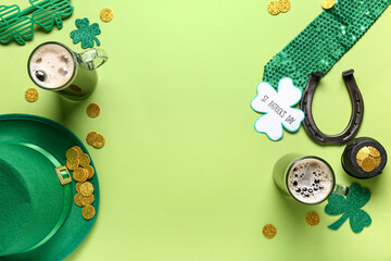 Mugs of dark beer with leprechaun hat, horseshoe and decor for St. Patrick's Day celebration on...