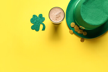 Glass of dark beer with leprechaun hat, coins and clover for St. Patrick's Day celebration on...