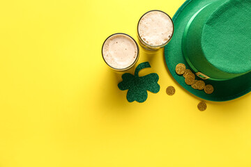 Glasses of dark beer with leprechaun hat, coins and clover for St. Patrick's Day celebration on yellow background - obrazy, fototapety, plakaty