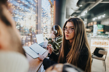 Young colleagues collaborating on a project in a modern office at night.
