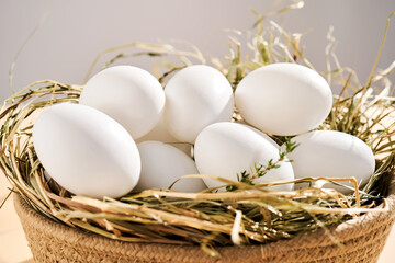 Wicker basket with farm natural white eggs.