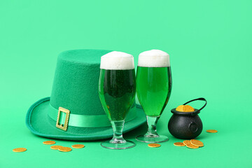 Glasses of beer with leprechaun hat and coins on green background. St. Patrick's Day celebration