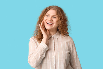 Beautiful happy young woman on blue background