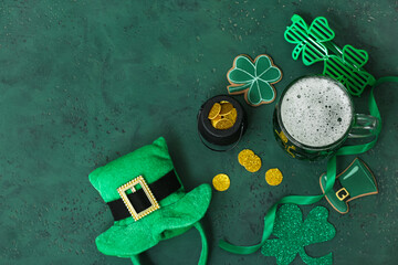 Glass of green beer with clover leaves, Leprechaun's hat and pot full of coins on green background....