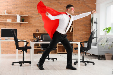 Businessman dressed as superhero in office