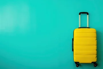 Zelfklevend Fotobehang a yellow suitcase is sitting on a blue background © cheese78